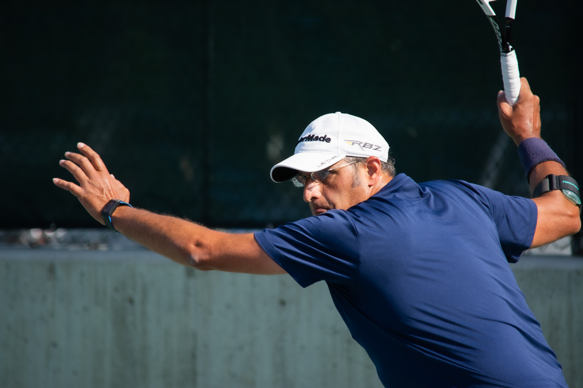 Man playing tennis at the Salt Lake Tennis and Health Cluib