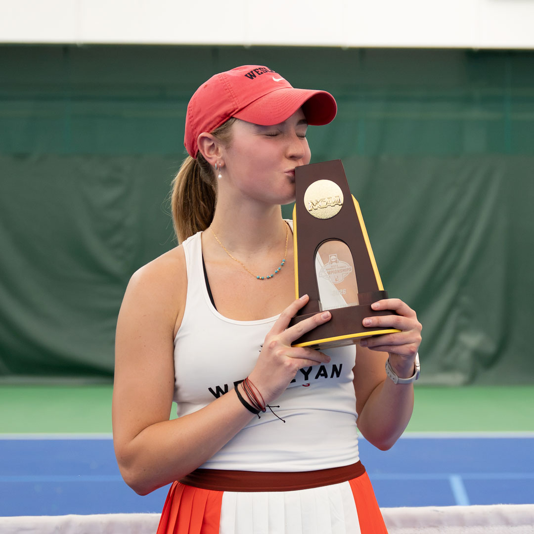 Rosie Burnett kissing her national championship trophy