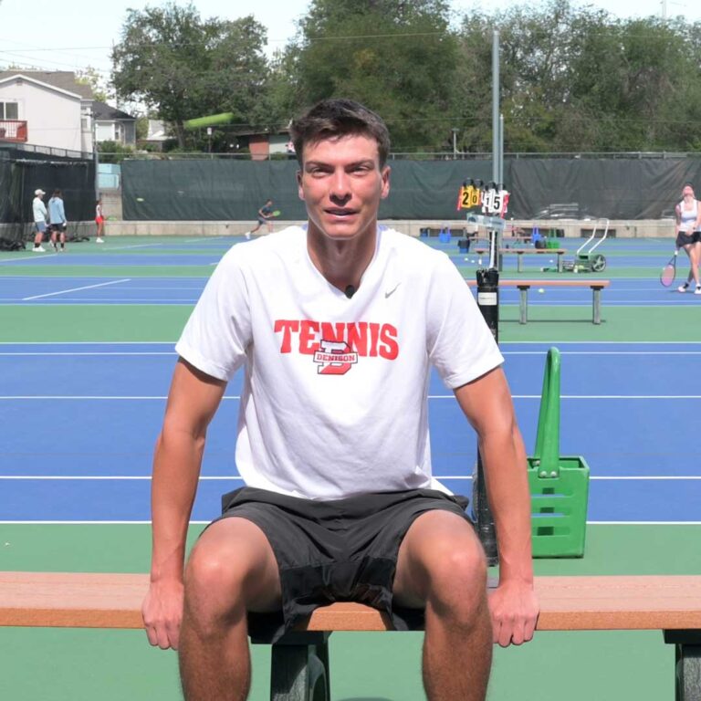 Ethan Green sitting courtside at the club