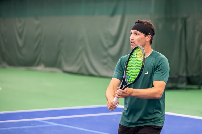 Tennis pro hitting a backhand volley