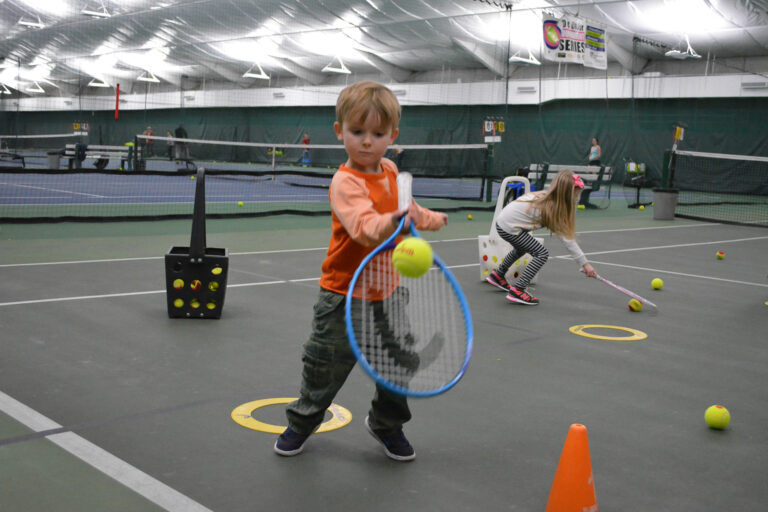 Young ROG player hitting a forehand with an orange tennis ball