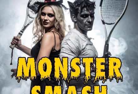 two adults wearing halloween costumes, standing back to back holding tennis rackets and a headline that reads "Monster Smash"